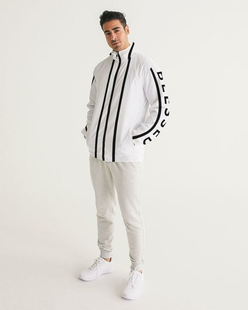 Man wearing a white tracksuit with black stripes and logo on a light gray background