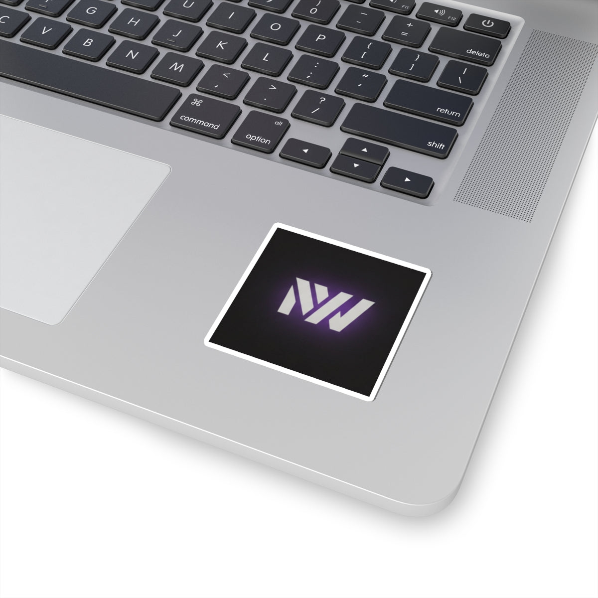 Laptop with a sticker featuring a logo on the touchpad area