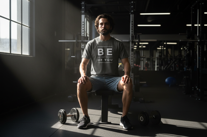 Person wearing a gray t-shirt with motivational text on a white background